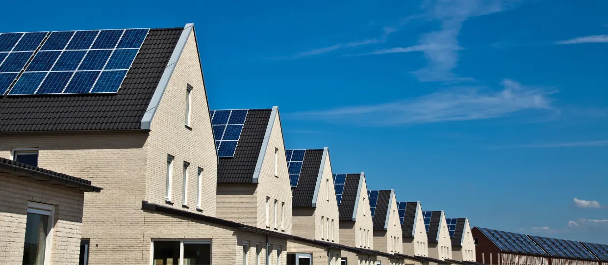 This picture shows a row of terrace houses with solar panels.
